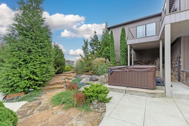 view of patio / terrace with a hot tub