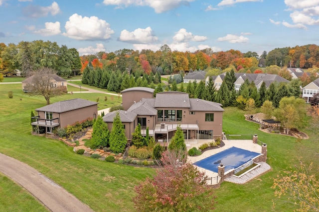 17311 Gambier Rd, Mount Vernon, OH 43050 - back of house with a deck, a covered pool, a lawn, a patio area, and a residential view