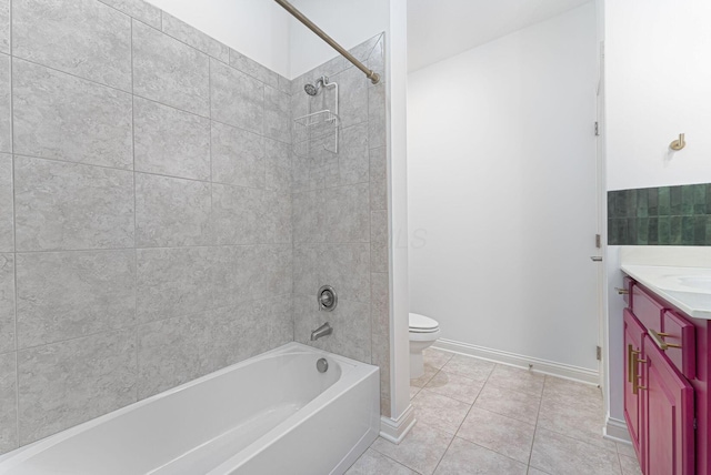 full bathroom featuring tile patterned flooring, vanity, toilet, and tiled shower / bath combo