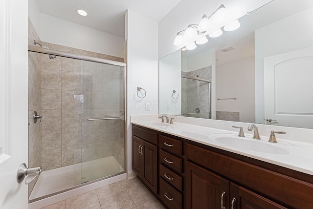 bathroom featuring tile patterned floors, vanity, and walk in shower