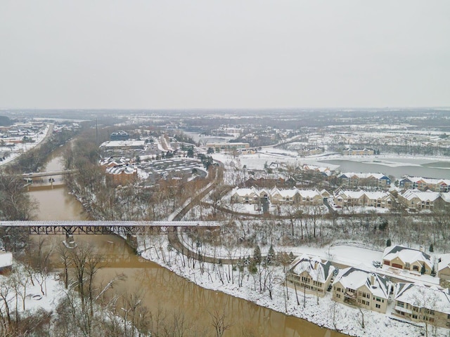 snowy aerial view featuring a water view