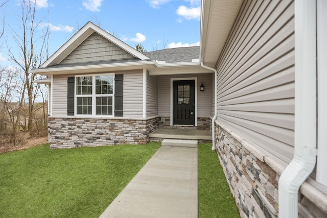 entrance to property featuring a yard