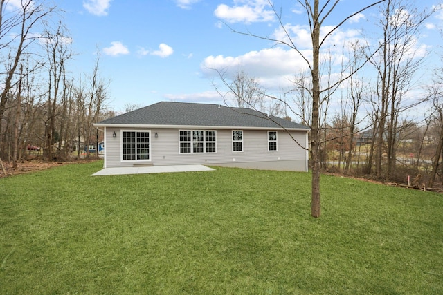 rear view of property with a yard and a patio