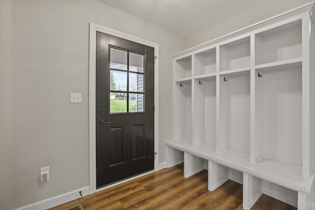 mudroom with a textured ceiling and dark wood-type flooring