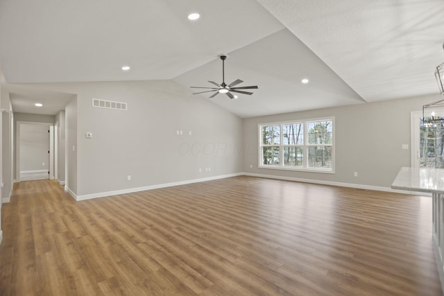 unfurnished living room featuring ceiling fan, hardwood / wood-style floors, and lofted ceiling