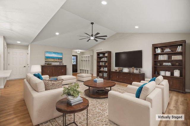 living room featuring light hardwood / wood-style floors, ceiling fan, and lofted ceiling