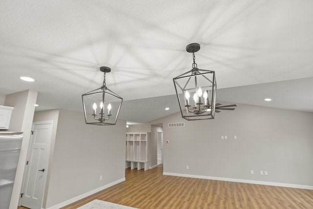 interior space featuring ceiling fan, wood-type flooring, and lofted ceiling