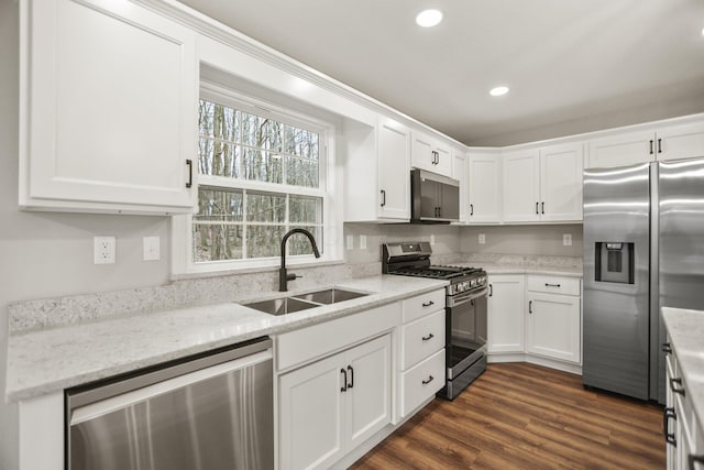 kitchen featuring light stone countertops, stainless steel appliances, white cabinetry, and sink