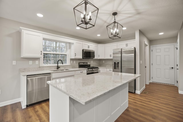 kitchen featuring pendant lighting, a center island, sink, and stainless steel appliances