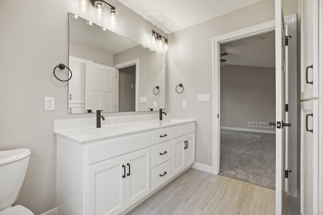 bathroom featuring vanity and toilet