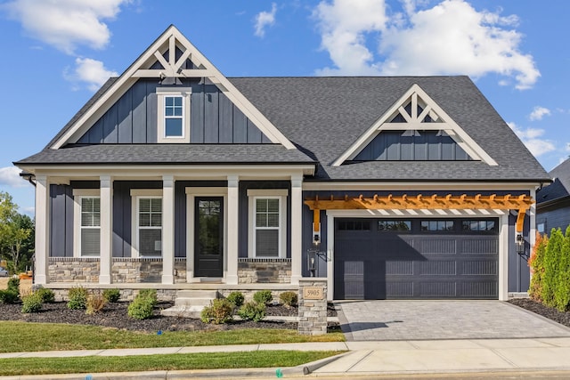 craftsman inspired home featuring covered porch and a garage