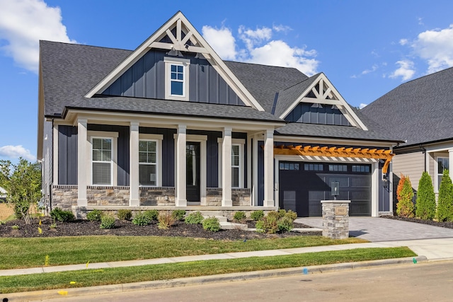 craftsman inspired home with covered porch and a garage