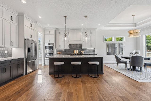 kitchen with white cabinetry, light hardwood / wood-style floors, and appliances with stainless steel finishes