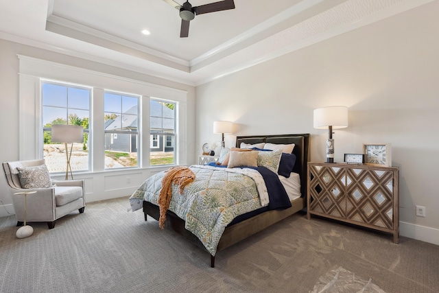 bedroom with ceiling fan, ornamental molding, carpet floors, and a tray ceiling