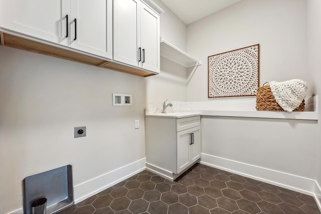 washroom featuring cabinets, dark tile patterned flooring, sink, washer hookup, and hookup for an electric dryer