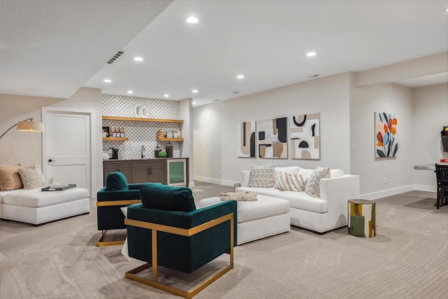 living room with light colored carpet and wet bar