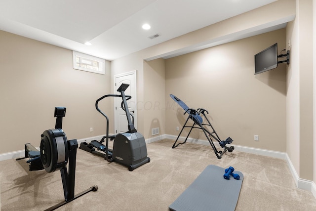 workout room featuring light colored carpet