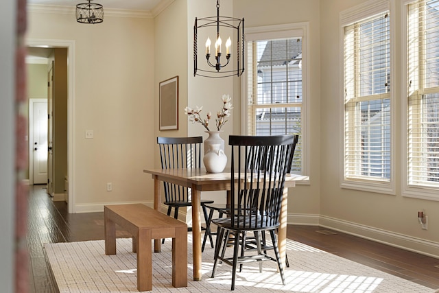 dining room with dark hardwood / wood-style flooring, plenty of natural light, and a chandelier