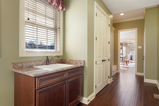 bathroom with hardwood / wood-style flooring, vanity, and ornamental molding