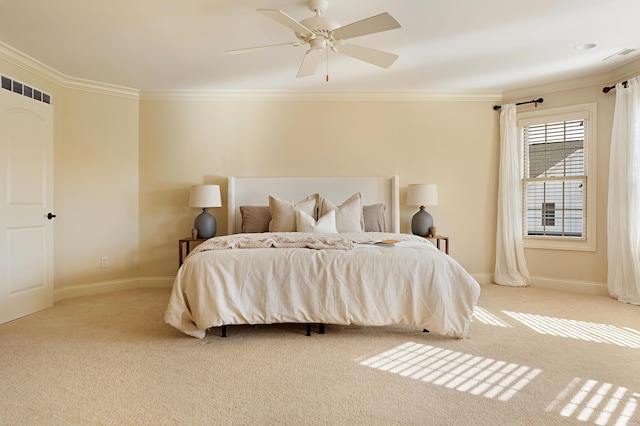 bedroom with ornamental molding, light colored carpet, and ceiling fan