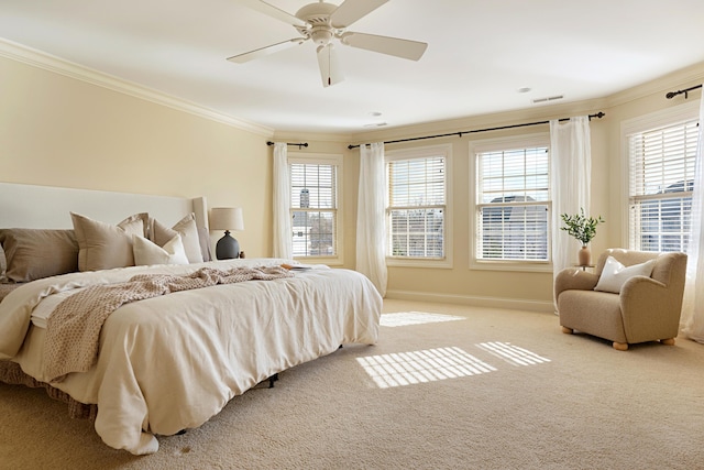 carpeted bedroom featuring multiple windows, crown molding, and ceiling fan