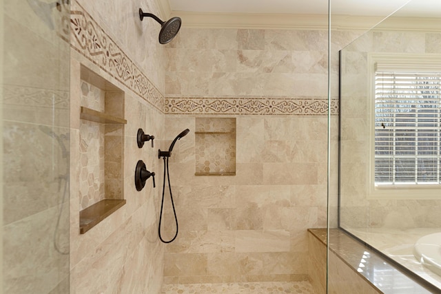 bathroom featuring ornamental molding and tiled shower