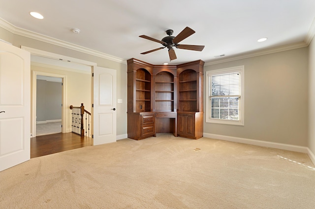 interior space featuring light colored carpet, ornamental molding, and ceiling fan