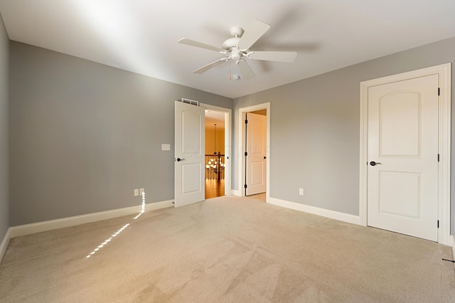 unfurnished bedroom with ceiling fan and light colored carpet