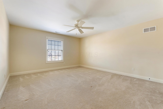 unfurnished room with light carpet and ceiling fan