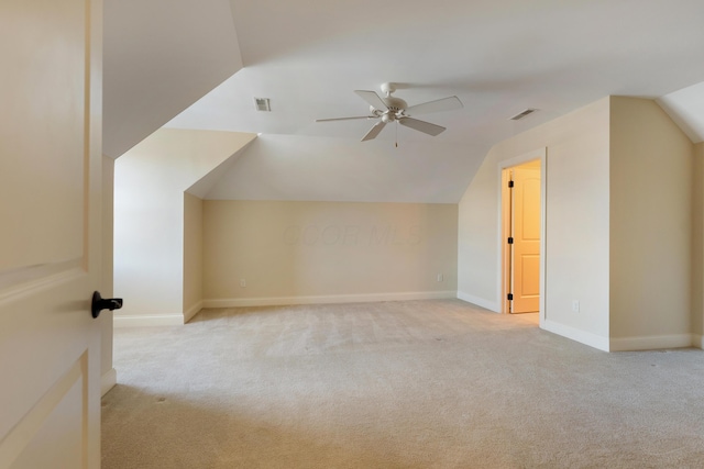 additional living space featuring lofted ceiling, light colored carpet, and ceiling fan