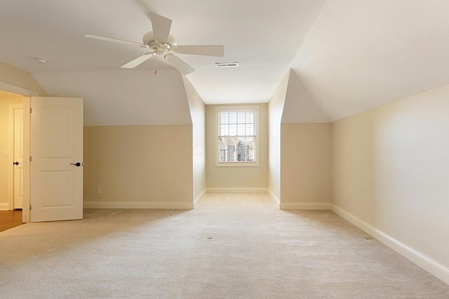 additional living space featuring vaulted ceiling, light carpet, and ceiling fan