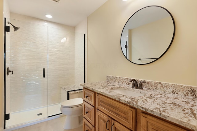 bathroom featuring walk in shower, vanity, and toilet