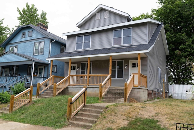 780-782 Seymour Ave, Columbus, OH 43205 - american foursquare style home with covered porch, roof with shingles, stairs, and a front lawn