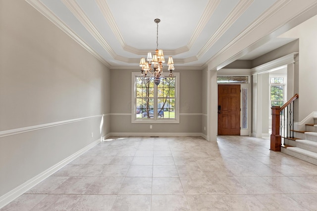 interior space featuring a tray ceiling, crown molding, and a notable chandelier