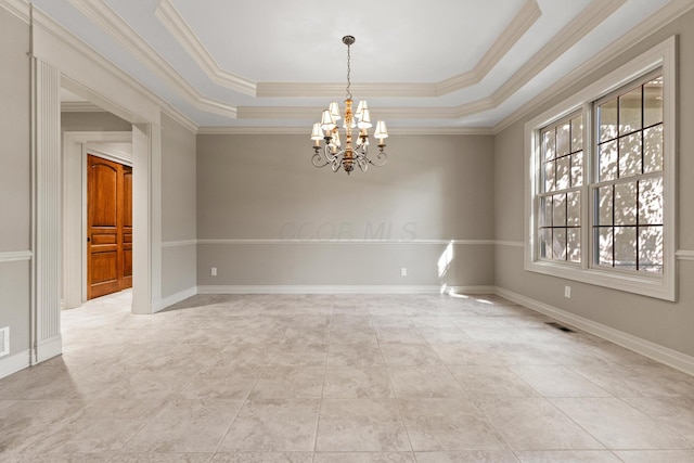 unfurnished room with a tray ceiling, ornamental molding, and an inviting chandelier