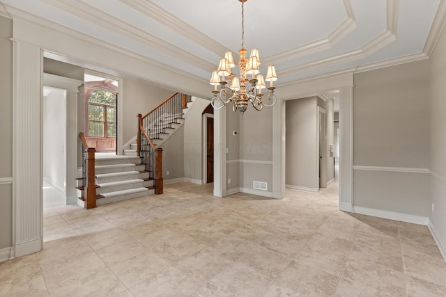 unfurnished room with a raised ceiling, crown molding, and a chandelier