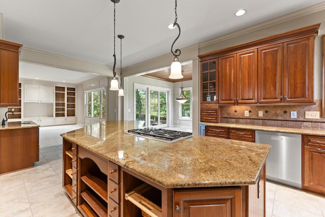 kitchen with decorative light fixtures, a center island, light stone countertops, and appliances with stainless steel finishes