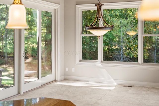 interior space with plenty of natural light and light tile patterned flooring