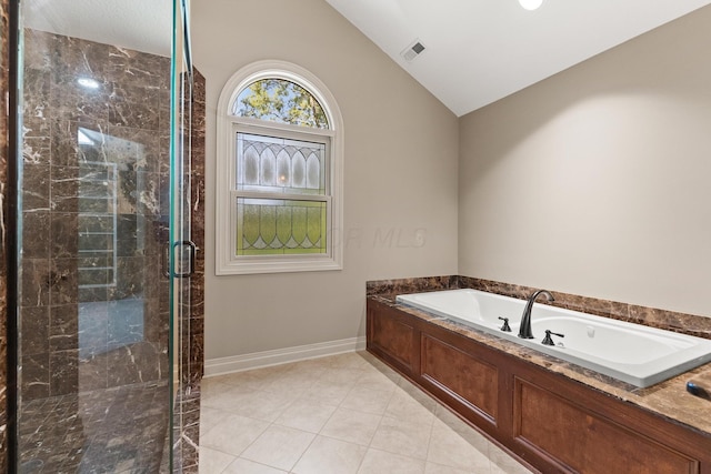 bathroom featuring separate shower and tub, tile patterned floors, and vaulted ceiling