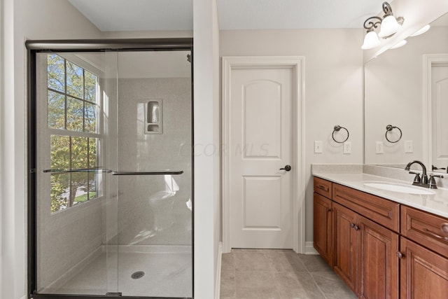 bathroom featuring tile patterned flooring, vanity, and an enclosed shower