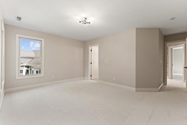 carpeted spare room featuring a textured ceiling