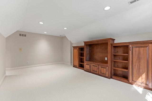 unfurnished living room featuring carpet flooring and vaulted ceiling