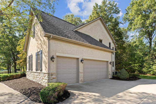 view of side of home featuring a garage