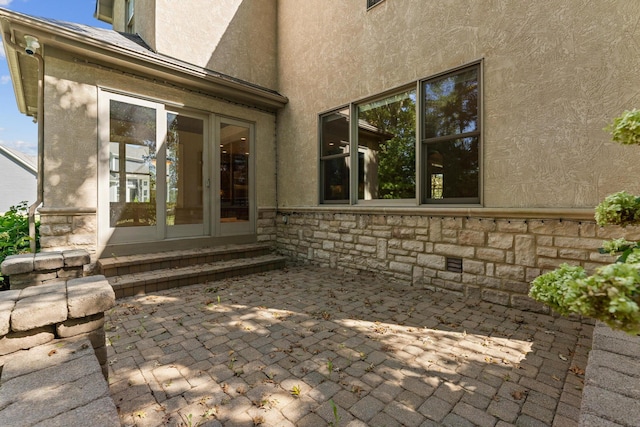 property entrance with a patio and french doors