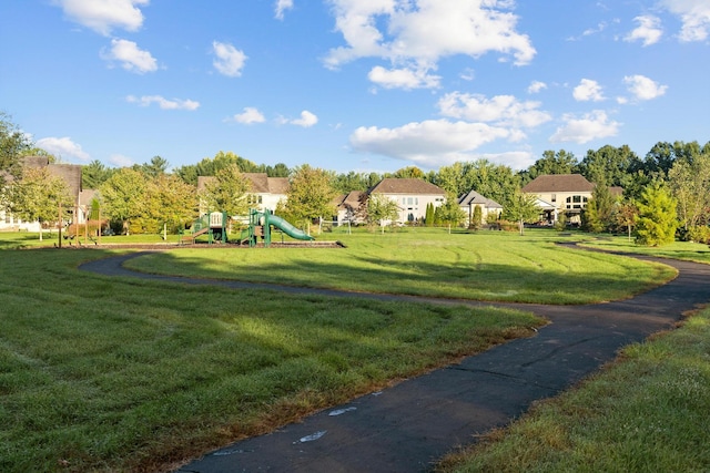 surrounding community with a yard and a playground