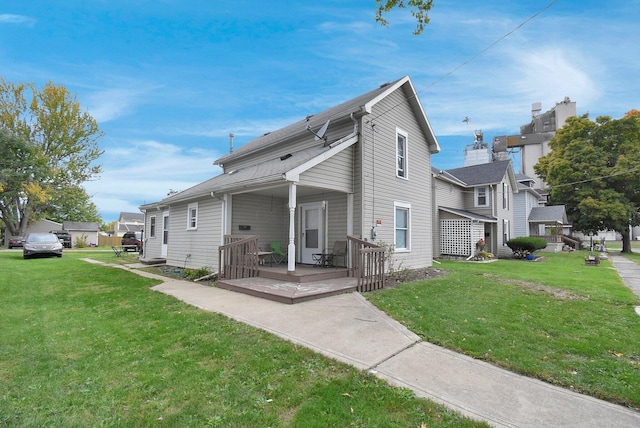 back of property featuring a porch and a lawn