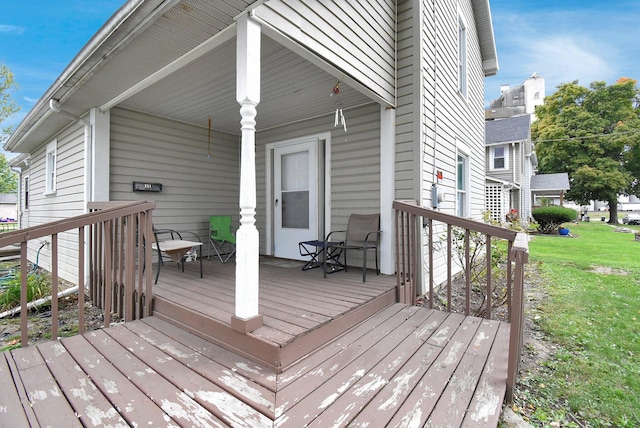 deck featuring a yard and a porch