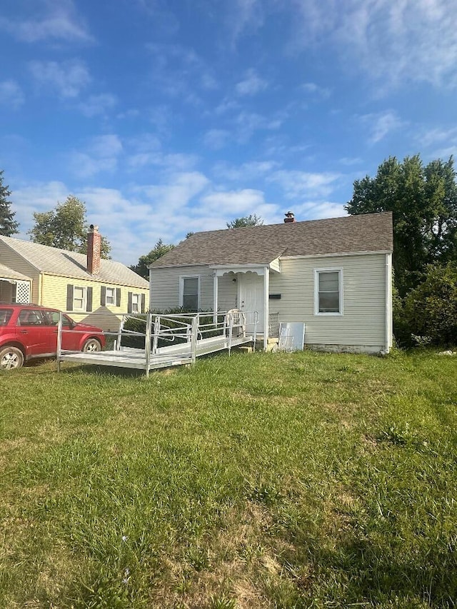 back of house featuring a yard and a deck