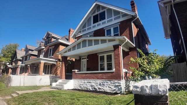 view of front of house featuring a porch and a front lawn