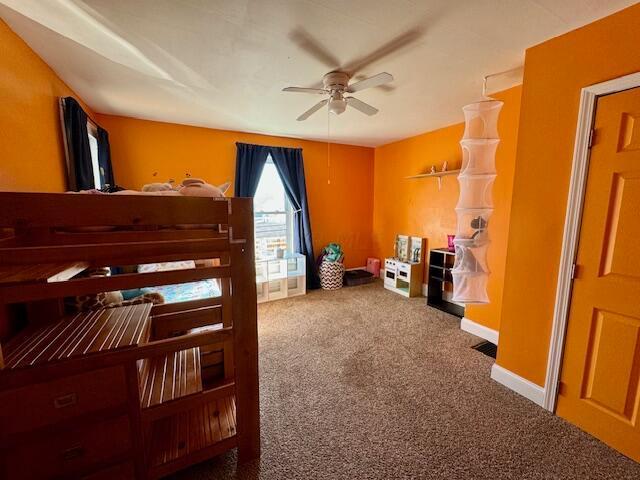 bedroom with ceiling fan and carpet floors